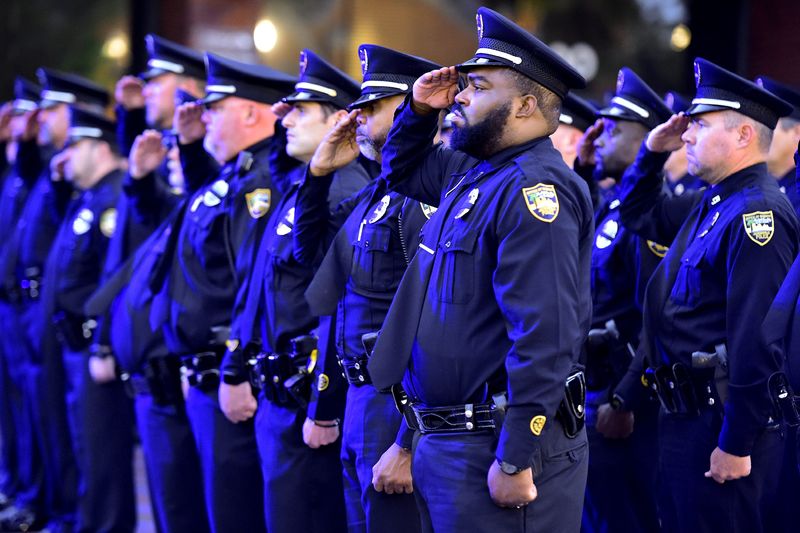 JSO officers salute during the singing of the National Anthem during a 2022 ceremony honoring fallen Jacksonville law enforcement members.