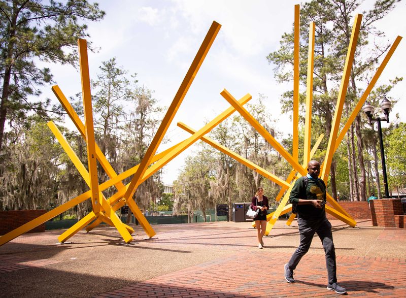 University of Florida students make their way by the John Raymond Henry sculpture Alachua, more commonly known as "The French Fries," near the Marston Science Library on campus in Gainesville.