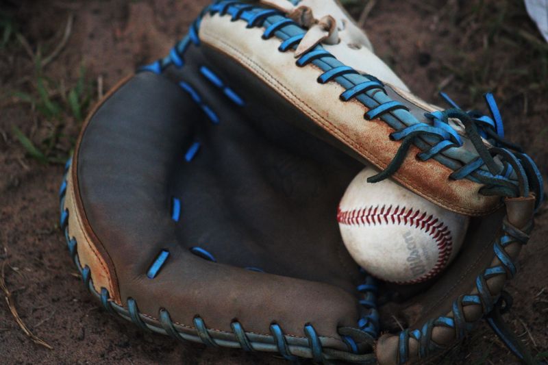 STOCK | A baseball and mitt rest on the field during an FHSAA Region 1-5A high school baseball quarterfinal between Columbia and Beachside in St. Johns, Florida, on May 7, 2024. [Clayton Freeman/Florida Times-Union]