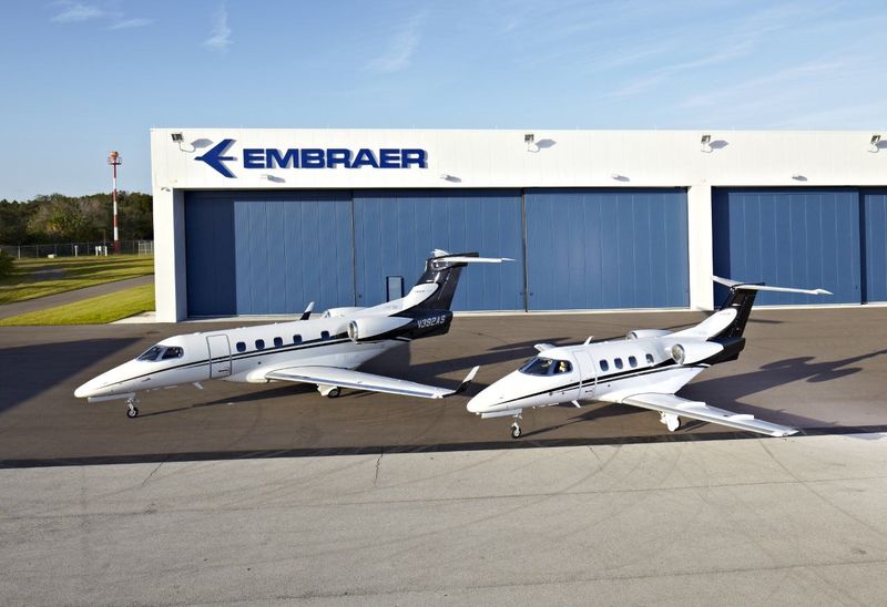 Two Embraer executive jets are parked outside the company's customer center at Melbourne Orlando International Airport.