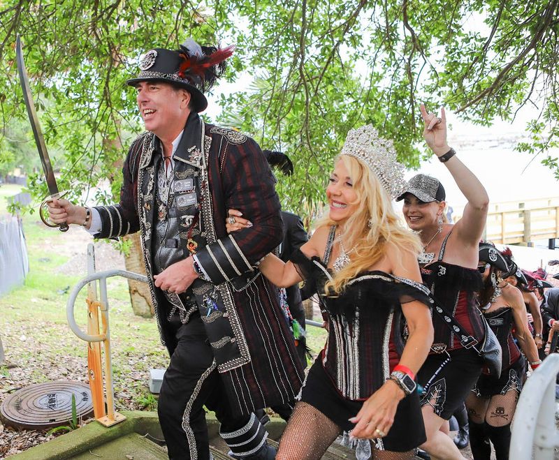 Captain Billy LXVIII Bill Kilpatrick and Queen LXVIII Sharen Burt lead their pirates up to land during the 68th Billy Bowlegs Pirate Festival at the Fort Walton Beach Landing.