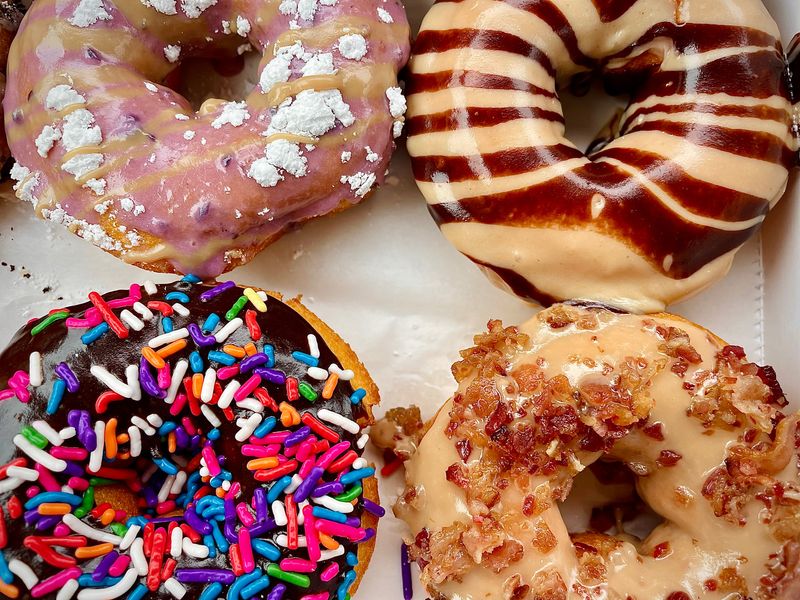 Blueberry pancake (top left), peanut butter paradise (top right), chocolate sprinkles (bottom left) and maple bacon (bottom right) doughnuts from Duck Donuts in Daytona Beach.