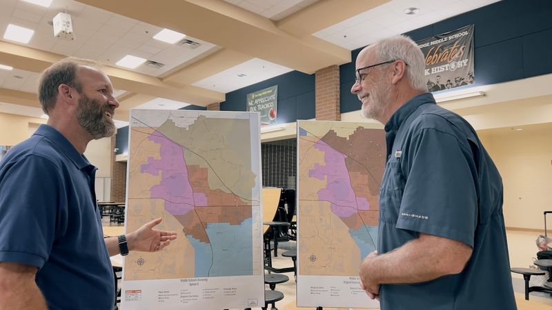 School Board district 3 representative Marc Dodd and Minneola Mayor Pat Kelley discuss new boundary maps at an East Ridge Middle School open house on May 20, 2024.