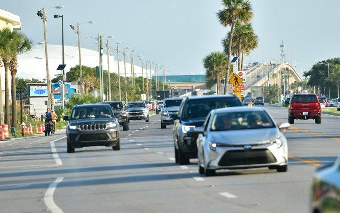 A steady procession of cars flows onto Pensacola Beach early on Saturday, July 13, 2024, to watch the Blue Angels beach air show.