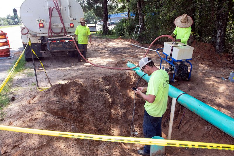 Worker crews from Chavers Construction pressure tests a newly installed sewer pipe section in East Milton on Tuesday, July 30, 2024. The new pipeline project is designed to remove over 2 million gallons per day (MGD) of treated effluent from the Blackwater River. This pipeline has already been extended more than 2 miles from the downtown Milton plant to South Airport Road. It will soon extend another 4 miles to an intermediate Santa Rosa Industrial Park storage system. From there, the effluent will be routed to the city’s new sprayfields for final disposal.