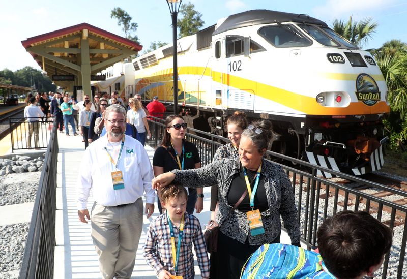Riders disembark the SunRail train after arriving at the DeLand SunRain station, Friday morning August 9, 2024 for the official opening..