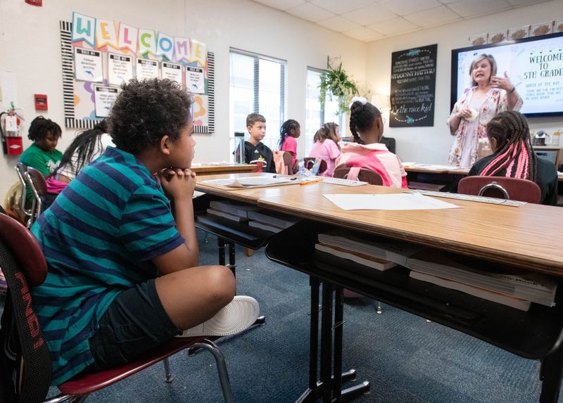 Noah Landrum, left, listens as 5th grade teacher April Scott welcomes the class on the first day of school at O.J. Semmes Elementary School in Pensacola on Monday, Aug. 12, 2024.