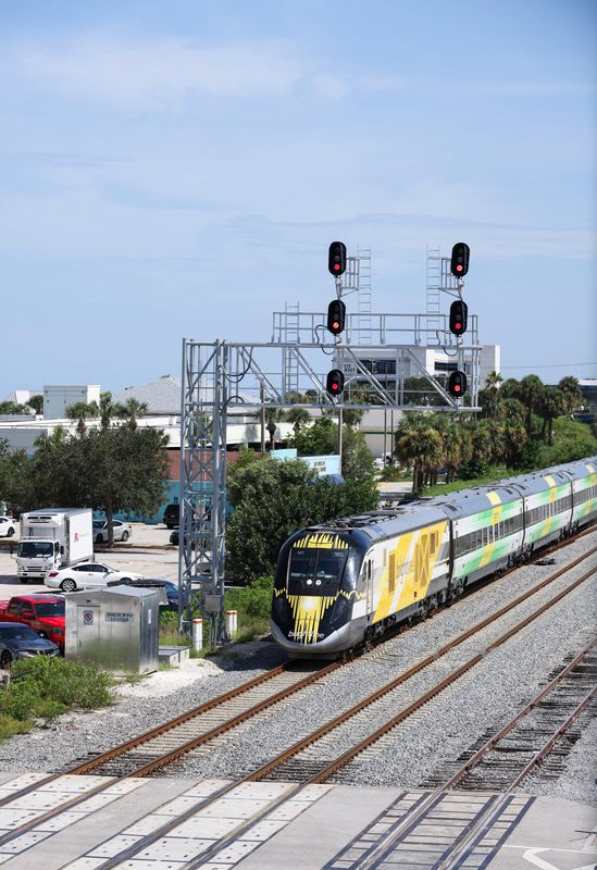 A Brightline train with service to Orlando travels north through downtown Fort Pierce on Wednesday, Aug. 14, 2024.