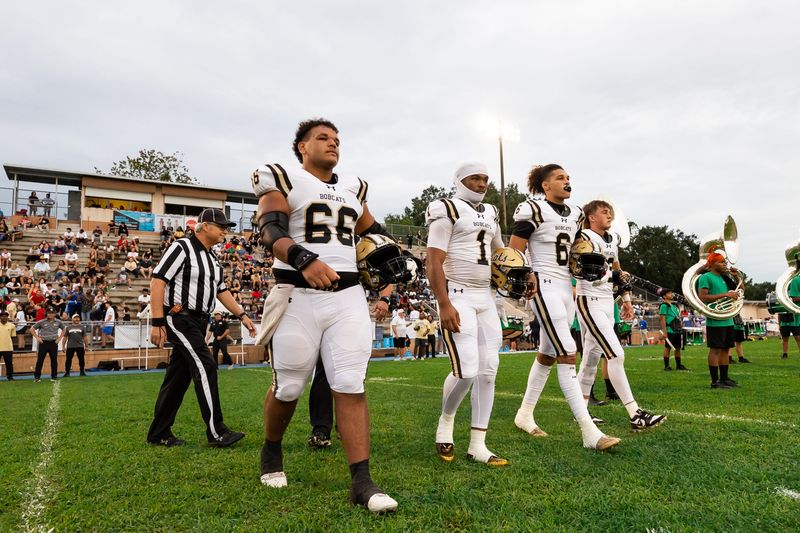 Buchholz Bobcats center Kain McDonald (66), Buchholz Bobcats strong safety RJ Livingston (1), Buchholz Bobcats defensive end Nick Clayton (6) and Buchholz Bobcats quarterback Trace Johnson (12) walk to midfield against the Eastside Rams before the game at Citizens Field in Gainesville, FL on Friday, September 6, 2024. [Matt Pendleton/Gainesville Sun]