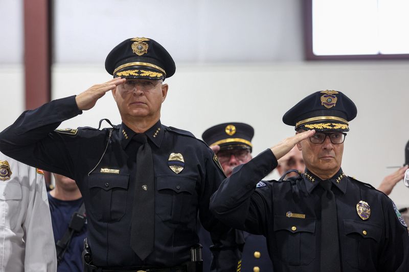 Fellsmere Police Chief Keith Touchberry and Vero Beach Police Chief David Currey salute during a 9/11 Memorial Ceremony, Wednesday, Sept. 11, 2024, at the Indian River County Fairgrounds Expo Center. The multi-agency ceremony included a first-hand account from retired Secret Service Agent Don Vinci of the events that happened 23 years ago; ringing of six bells; a rifle volley; playing of Taps, and bagpipes from Vero Beach Pipes and Drums.