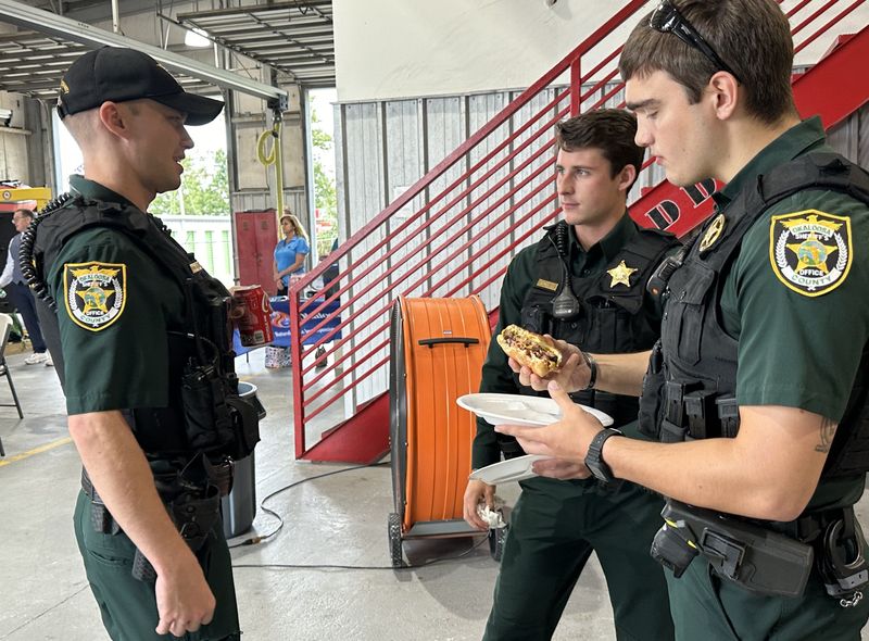 Not all first reponders that attended the cookout were around when 9/11 happened in 2001, but they do remember and appreciated the burgers on Wednesday. Standing from left are Okaloosa County Sheriff deputies Michael Galleger, Ryan King and Michael Whaley.