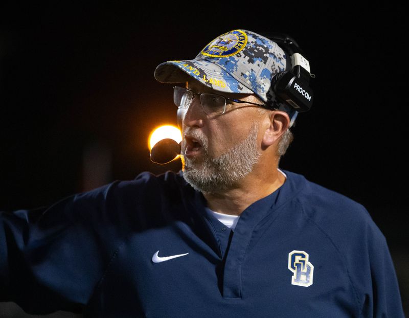 Dolphins head coach Jim Stomps keeps an eye on the action during the Booker T. Washington vs Gulf Breeze football game at Gulf Breeze High School on Friday, Sept. 20, 2024.