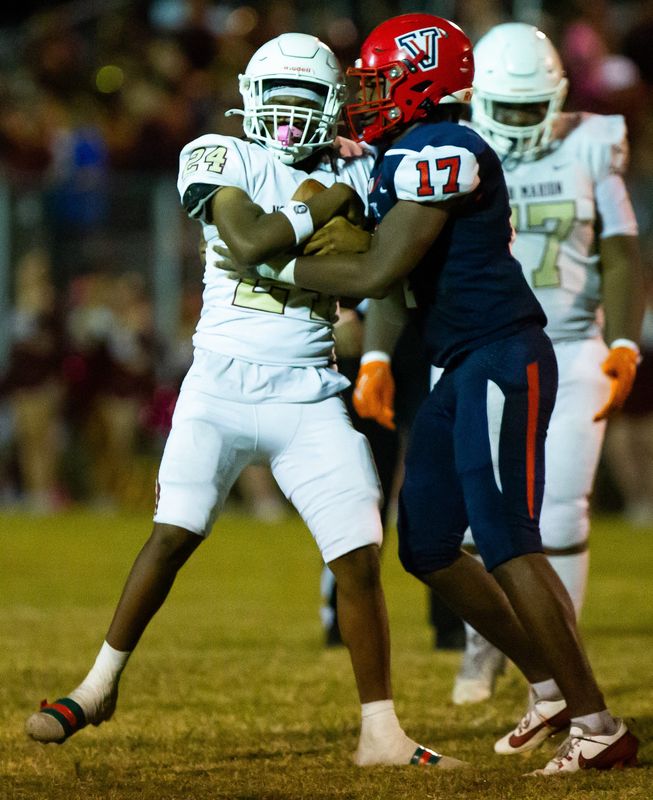 Vangaurd Knights defensive end Kelvin Pinkney Jr. (17) stops North Marion Amadrick Hope in the first half. The Vanguard Knights hosted the North Marion Colts at Booster Stadium in Ocala, FL on Friday, October 4, 2024. Vanguard lead 21-6 at the half. [Doug Engle/Ocala Star Banner]