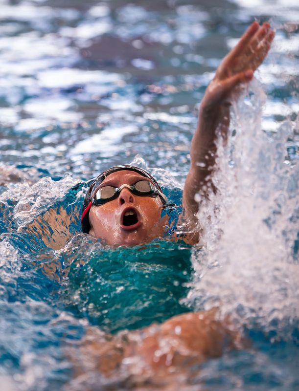 West Port’s Evelyn Milak does the backstroke while competing in the Girls 200 Yard IM. Area high schools competed in the Mid-Florida Conference 2024 at the Florida Aquatics Swimming Training in Ocala, Fla. Saturday October 5, 2024. [Doug Engle/Ocala Star Banner]2024
