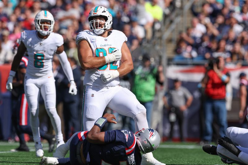 Oct 6, 2024; Foxborough, Massachusetts, USA; Miami Dolphins defensive tackle Zach Sieler (92) celebrates after a sack of New England Patriots quarterback Jacoby Brissett (7) during the first half at Gillette Stadium. Mandatory Credit: Paul Rutherford-Imagn Images
