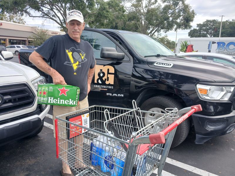 John Bracken, 69, of Deltona, loads hurricane supplies into his truck on Tuesday in the parking lot of the Winn-Dixie at DeBary Commons shopping plaza. "It looks like it's going to be a rough one," he said of Hurricane Milton.