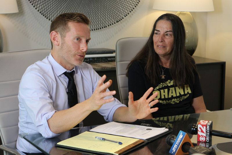 Julie Kiedis-Szukics, right, listens as lawyer Scott M. Fischer describes the events that led up to a fatal fire at Colonial Assisted Living facility in May. Kiedis-Szukics, whose 80-year-old father died in the fire, intends to sue the facility for wrongful death.