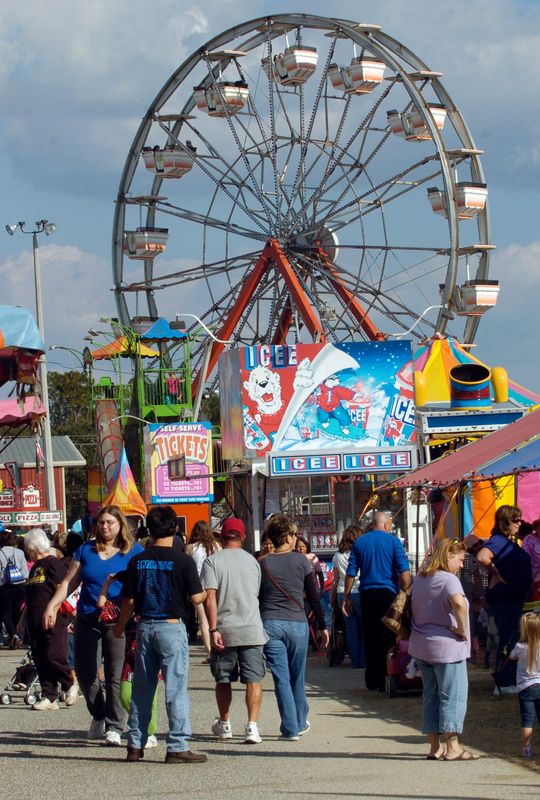 Fairgoers check out the variety of rides and games at the Pensacola Interstate Fair Monday Oct. 24, 2011.
