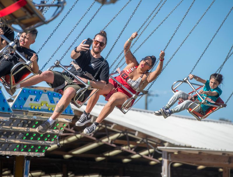 Fair fans take in the rides during the Pensacola Interstate Fair Sunday, October 20, 2024.