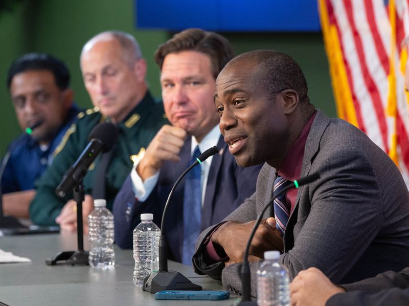 Florida Surgeon General Dr. Joe Ladapo, right, campaigns against Amendment 3 during a press conference at the Escambia County Sheriff's Office in Pensacola on Friday, Oct. 25, 2024.