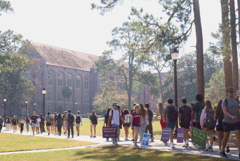 Students walk across Landis Green at Florida State University.