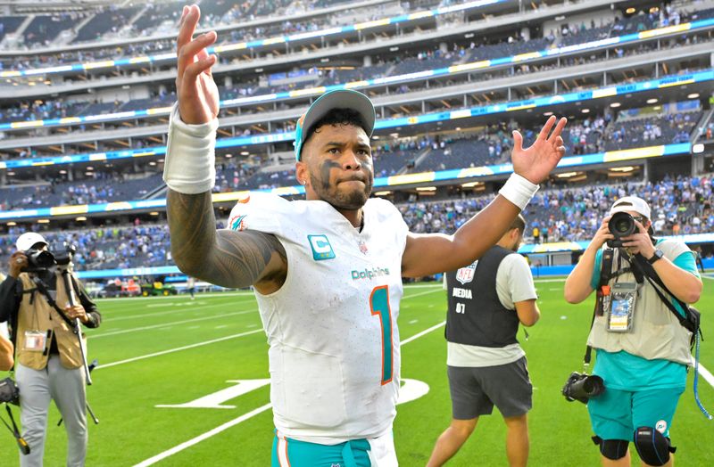Sep 10, 2023; Inglewood, California, USA; Miami Dolphins quarterback Tua Tagovailoa (1) celebrates as he leaves the field after defeating the Los Angeles Chargers 36-34 at SoFi Stadium. Mandatory Credit: Jayne Kamin-Oncea-USA TODAY Sports