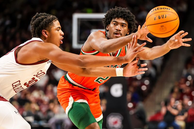Dec 30, 2023; Columbia, South Carolina, USA; Florida A&M Rattlers guard Jordan Chatman (2) passes around South Carolina Gamecocks forward Collin Murray-Boyles (30) in the second half at Colonial Life Arena. Mandatory Credit: Jeff Blake-USA TODAY Sports