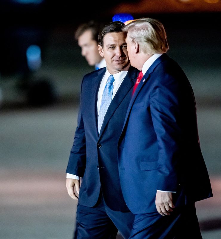 President Donald Trump walks with Governor Ron DeSantis after arriving on Air Force One at Palm Beach International Airport in West Palm Beach, Florida on Nov. 26, 2019.