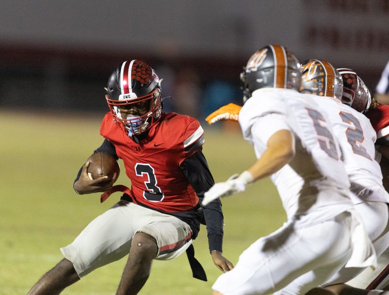Dunnellon quarterback Dylan Curry (3) evades Mount Dora Tanner Waring (5) and Mount Dora cornerback Jonathan Wilson (2) during a 3A FHSAA play off game at Dunnellon High School in Dunnellon, FL on Friday, November 15, 2024. [Alan Youngblood/Ocala Star-Banner]