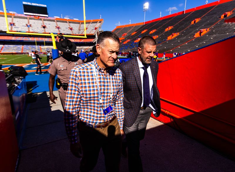 Florida Athletic Director Scott Stricklin, left, walks off the field with Florida Gators head coach Billy Napier during Gator Walk before the game against the LSU Tigers at Ben Hill Griffin Stadium in Gainesville, FL on Saturday, November 16, 2024. [Doug Engle/Gainesville Sun]