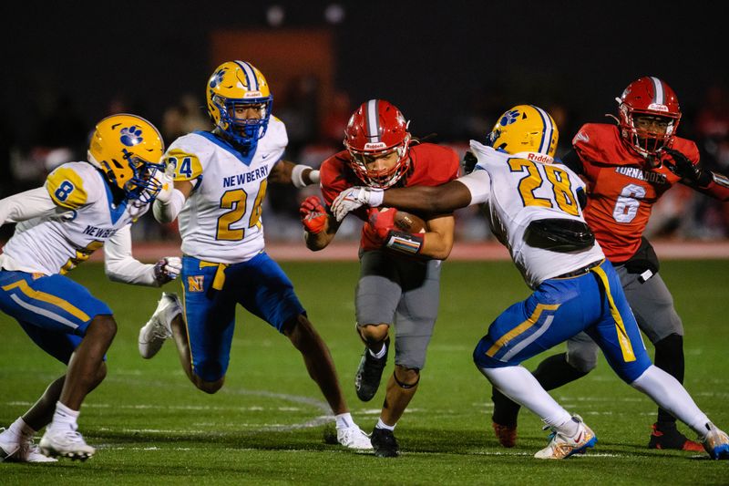 Bradford Tornadoes Branden Williams (9) is tackled by Newberry Panthers Davon Rim (28) during the Class 2A-Region 2 Semifinals game between Newberry High School and Bradford High School at Bradford High School in Starke, FL on Friday, November 22, 2024. [Chris Watkins/Gainesville Sun]