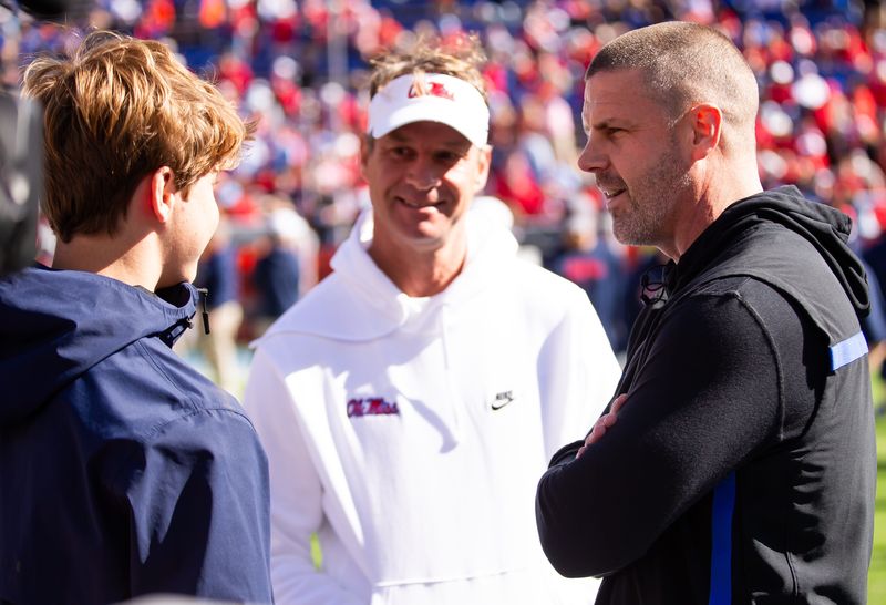 Florida Gators head coach Billy Napier talks with Mississippi Rebels head coach Lane Kiffin before the start of the game at Ben Hill Griffin Stadium in Gainesville, FL on Saturday, November 23, 2024. [Doug Engle/Gainesville Sun]