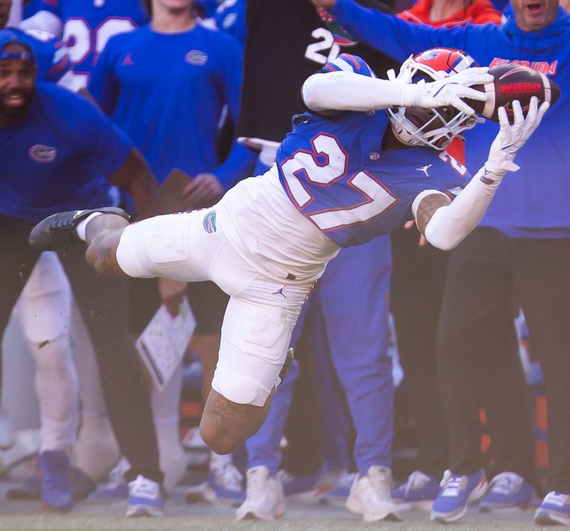 Florida Gators defensive back Dijon Johnson (27) intercepts the ball but was called back during the second half at Ben Hill Griffin Stadium in Gainesville, FL on Saturday, November 23, 2024. The Gators defeated the Rebels 24-17 [Doug Engle/Gainesville Sun]