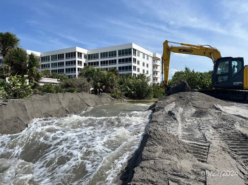 An excavator works clearing Flamingo Ditch, one of 10 stormwater outfalls on the island of Venice, Sept. 27, after Hurricane Helene. Storm surge from both Helene and Milton overtopped the dune system along Venice Beach causing flooding that was especially severe in Golden Beach and other neighborhoods near Flamingo Ditch.