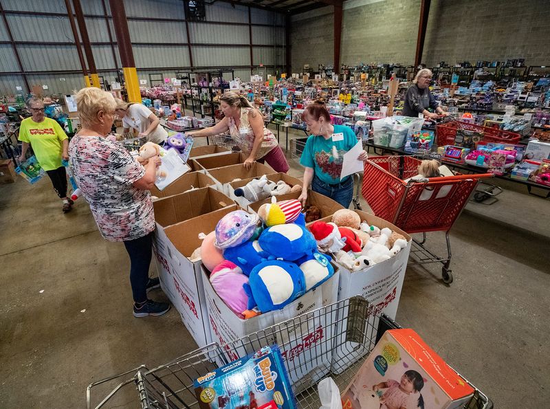 Volunteers sort toys at the Polk County Tots For Tots warehouse in Auburndale Monday Dec. 4, 2023.