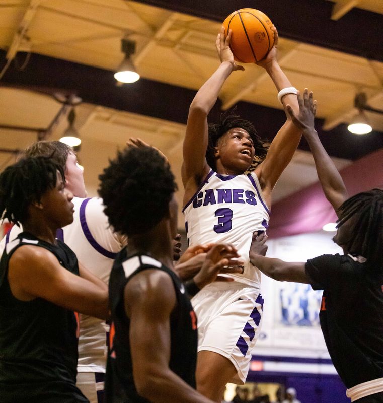 Gainesville Hurricanes Cordarius White (3) comes up with the rebound and shoots for two in the second half. The Gaineville Hurricanes hosted the P.K. Yonge Blue Wave at Citizens Field in Gainesville, FL on Tuesday, November 26, 2024. The Hurricanes defeated the Blue Wave 64-36. [Doug Engle/Ocala Star Banner]