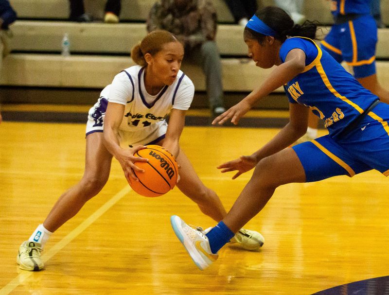 Gainesville Hurricanes Jayden Terry (11) steals the ball away from Newberry Panthers Sarah Beaulieu (3) in the first half. The Gainesville Hurricanes hosted the Newberry Panthers at Gainesville High School in Gainesville, FL on Tuesday, December 3, 2024. The Hurricanes defeated the Panthers 67-41. [Doug Engle/Ocala Star Banner]