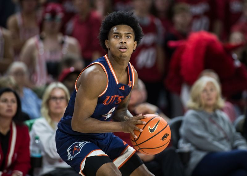 Texas-San Antonio guard Marcus Millender (4) gets ready to take a shot during the first half against Arkansas. UTSA is among 10 teams scheduled to compete in November's Jacksonville Classic.