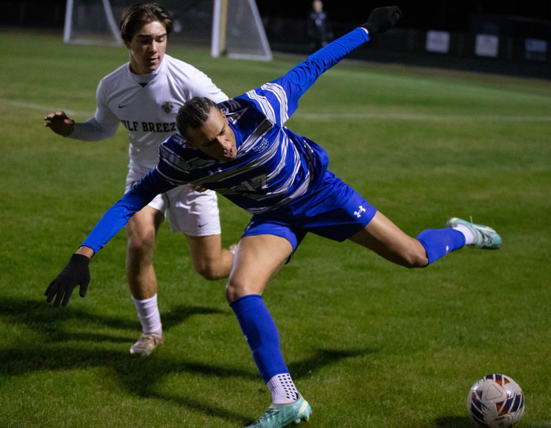 Keandre Hernandez (17) gets set to pass the ball during the Gulf Breeze vs Washington boys soccer game at Booker T. Washington High School in Pensacola on Thursday, Dec. 12, 2024.