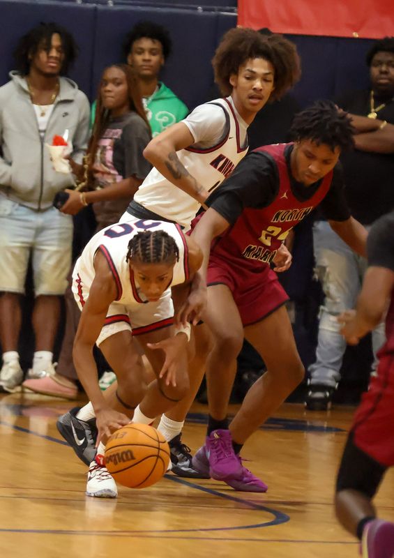 Vanguard guard Darnell Goodman (20) steals the ball from North Marion forward Lamont Sweeting JR (23) during the opening day of the annual Kingdom of the Sun Basketball Tournament at Vanguard High School in Ocala, FL on Friday, December 27, 2024. [Alan Youngblood/Ocala Star-Banner]