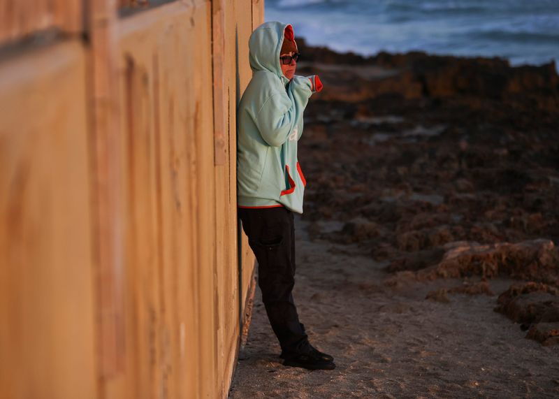 People are bundled up, during the early morning hours, to watch the sunrise, fish or exercise, Wednesday, Jan. 8, 2025, on Hutchinson Island in Martin County. A cold front associated with a winter storm impacting Midwest and Mid-Atlantic states drove low temperatures into the low-to-mid 40s this week, a meteorologist said. With 10-15 mph winds, 40s felt like the mid-30s in some areas of the Treasure Coast.