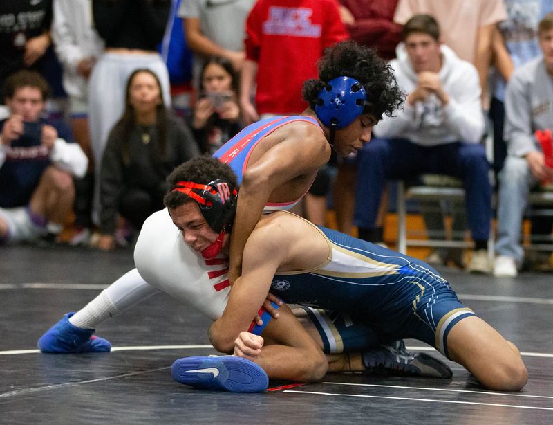 Dominik Baxter, of Pace HS, top, and Garrett Ferguson, of Gulf Breeze HS, face off in the 115 weight class during the finals of the District 1-2A Duals wrestling match at Gulf Breeze High School on Wednesday, Jan. 8, 2025.