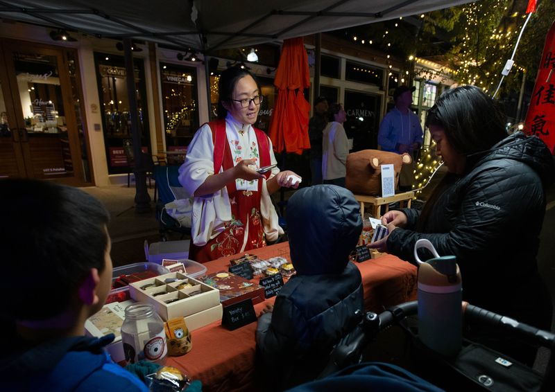 Liang Xu, owner of Pretty Bear Bakery, sells authentic Chinese pastries during the Lunar New Year is celebrated during Gallery Night in downtown Pensacola on Friday, Jan, 17, 2025.