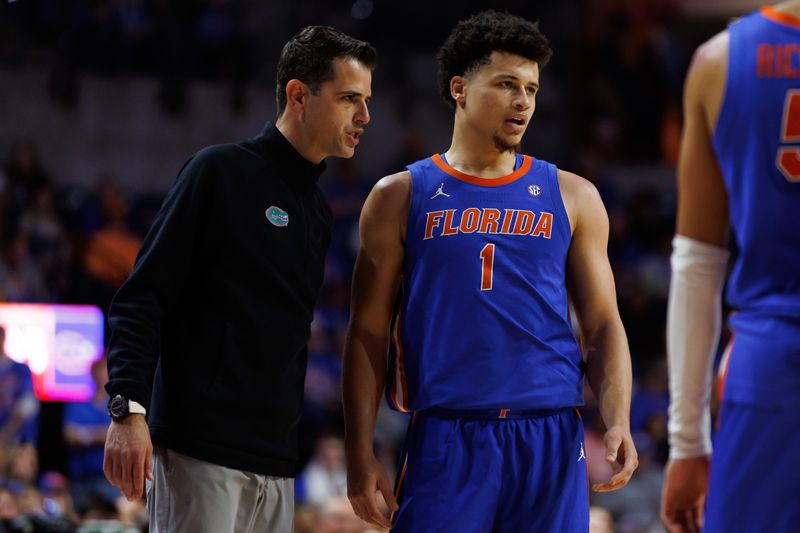 Jan 18, 2025; Gainesville, Florida, USA; Florida Gators head coach Todd Golden talks with Florida Gators guard Walter Clayton Jr. (1) during a free throw against the Texas Longhorns during the first half at Exactech Arena at the Stephen C. O'Connell Center. Mandatory Credit: Matt Pendleton-Imagn Images
