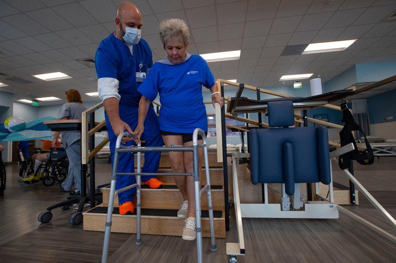 Cameron Ballard, a physical therapist assistant, works with patient Cindy Schmidt of Estero on hip strengthening exercises. 
Southwest Florida's largest hospitals have entered into joint ventures with Encompass Health, for inpatient rehab hospitals.