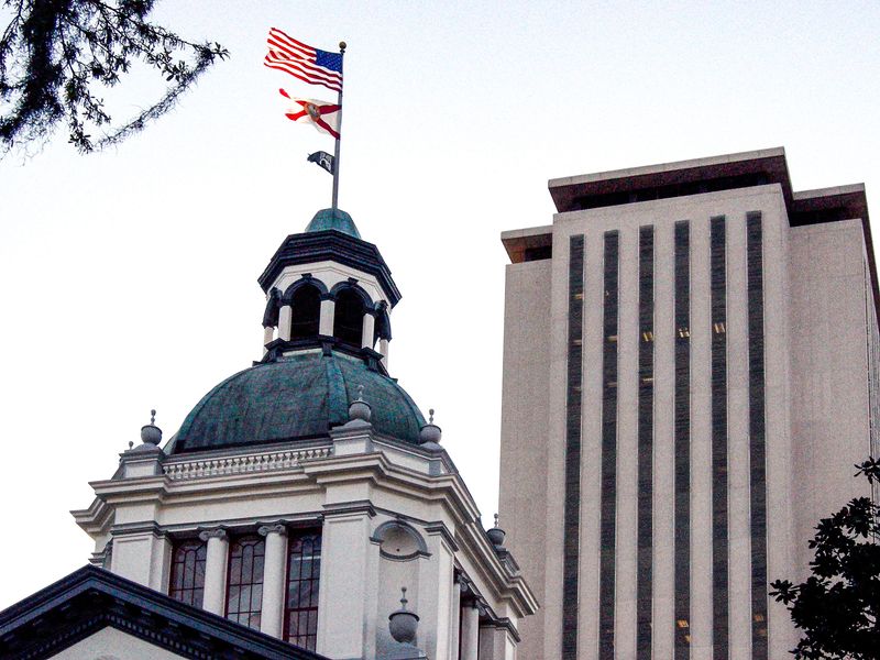 Florida's old and new capitol buildings at dusk.