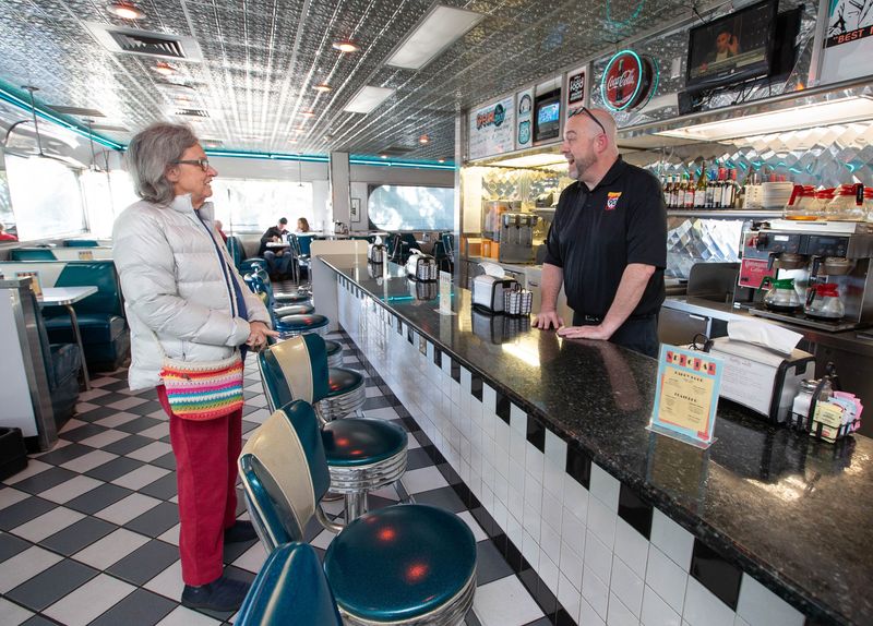 New owner Rod Bish, right, chats with a regular diner at the Scenic 90 Cafe in Pensacola on Friday, Jan. 24, 2025.