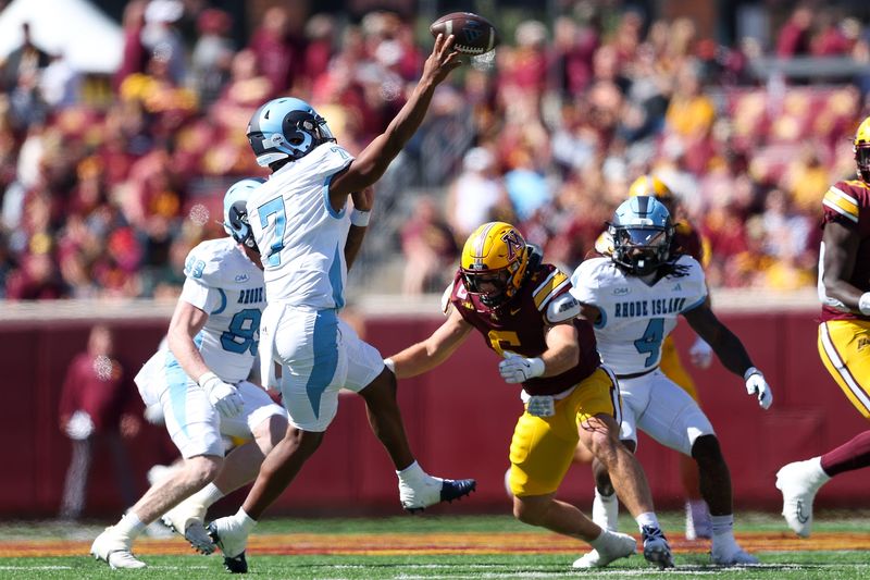 Sep 7, 2024; Minneapolis, Minnesota, USA; Rhode Island Rams quarterback Devin Farrell (7) throws the ball as Minnesota Golden Gophers linebacker Maverick Baranowski (6) defends during the first half at Huntington Bank Stadium. Mandatory Credit: Matt Krohn-Imagn Images