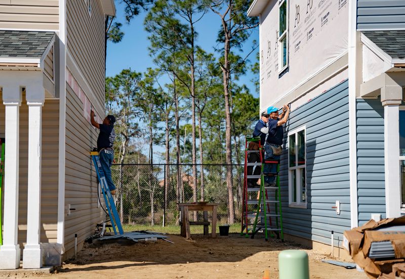 Habitat for Humanity of Collier County volunteers work alongside construction crews to build 109 single-family homes at the Majestic Place community in Naples, Fla., on Tuesday, Jan. 28, 2025.