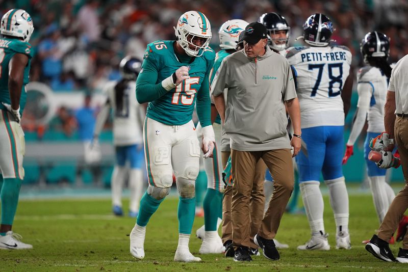 Sep 30, 2024; Miami Gardens, Florida, USA; Miami Dolphins linebacker Jaelan Phillips (15) walks off the field with a team trainer after an apparent injury during the second half against the Tennessee Titans at Hard Rock Stadium. Mandatory Credit: Jasen Vinlove-Imagn Images